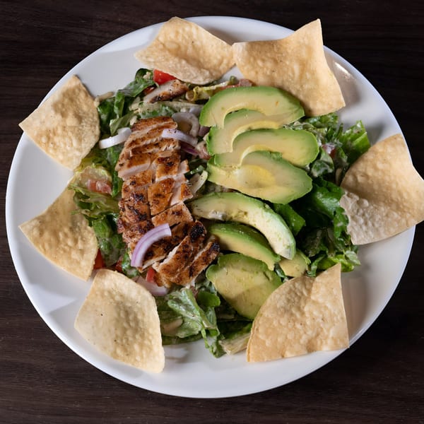 Tukee's Sports Grille's grilled chicken salad with avocado, red onion, and tortilla chips.
